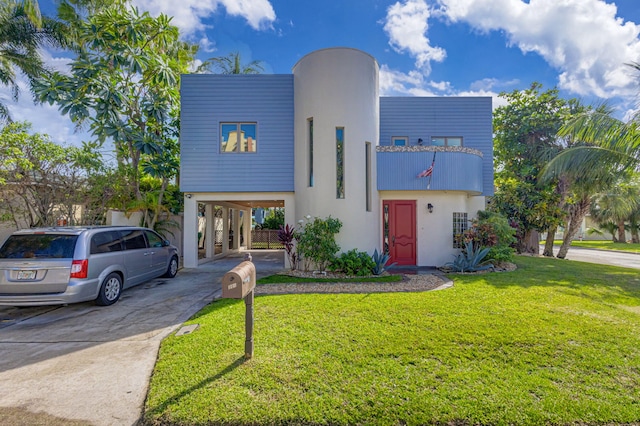 view of front facade with a front yard and a carport