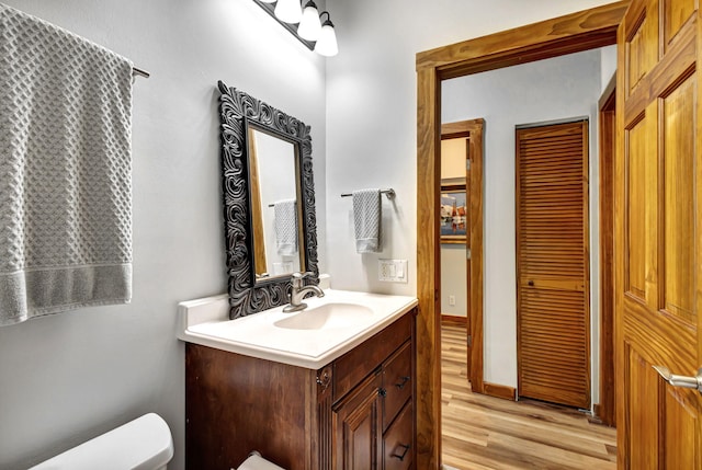 bathroom featuring vanity, toilet, and wood-type flooring