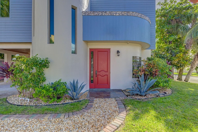 entrance to property featuring a yard