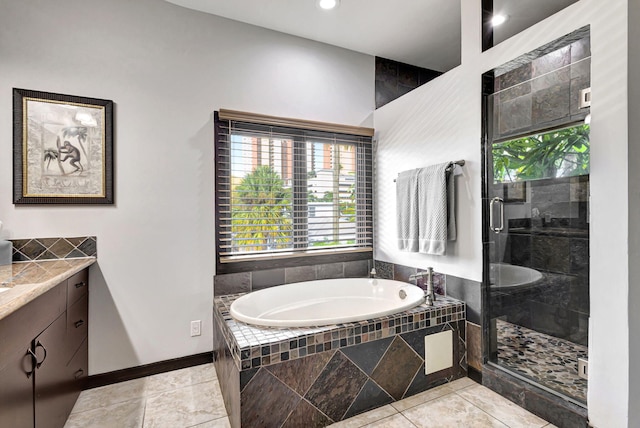 bathroom with vanity, independent shower and bath, and tile patterned floors