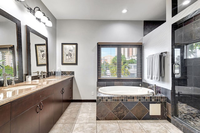 bathroom featuring vanity, tile patterned flooring, independent shower and bath, and a wealth of natural light