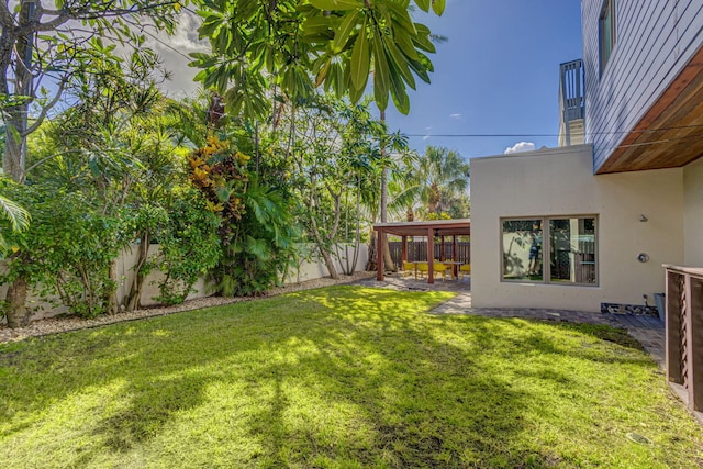 view of yard with a patio and a balcony