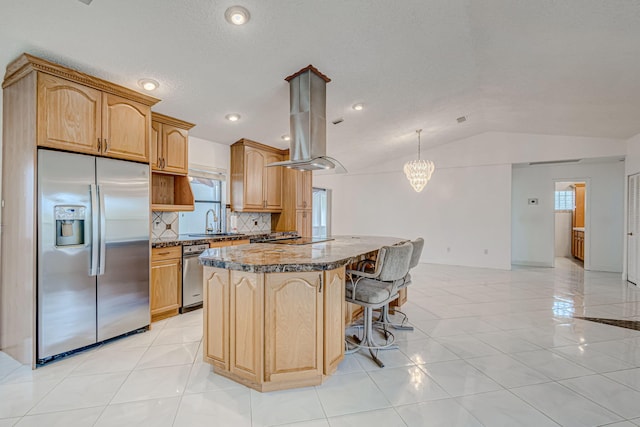 kitchen with dark stone countertops, a healthy amount of sunlight, lofted ceiling, and stainless steel refrigerator with ice dispenser