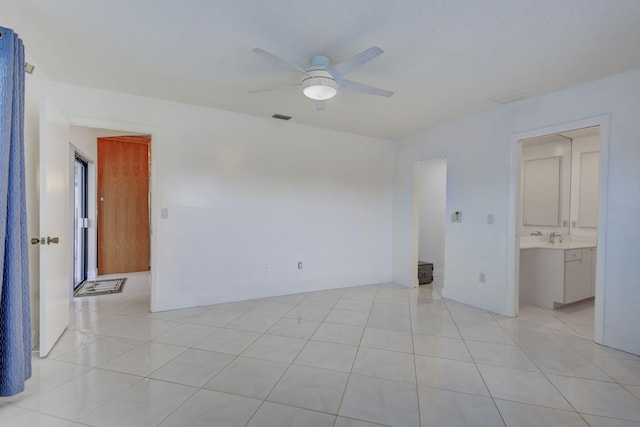 tiled empty room with ceiling fan