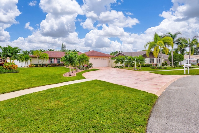 view of front of property with a front yard and a garage