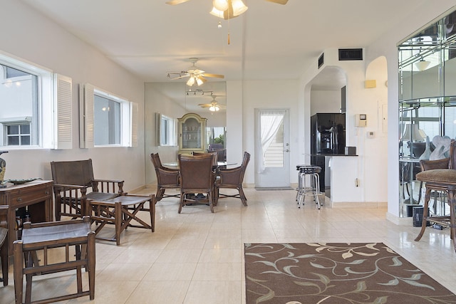 tiled dining space with ceiling fan