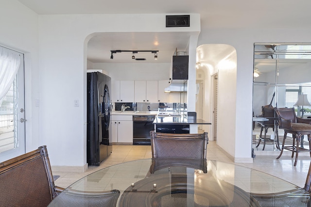 kitchen with black appliances, sink, light tile patterned floors, white cabinetry, and extractor fan