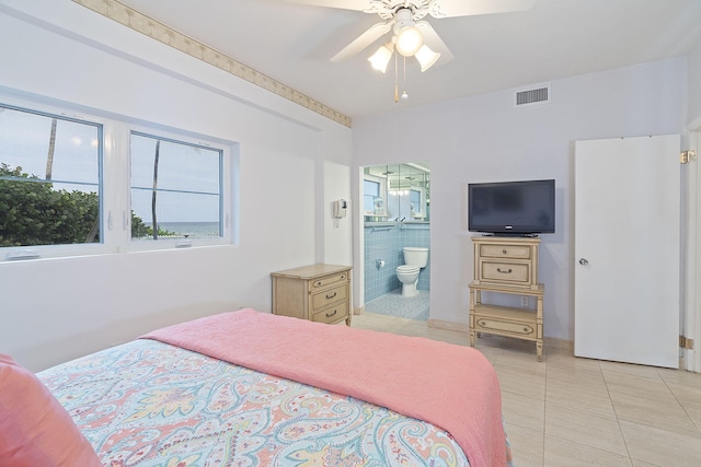 bedroom with connected bathroom, ceiling fan, and light tile patterned flooring