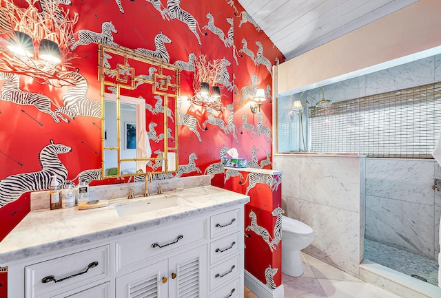 bathroom featuring toilet, tile patterned floors, vaulted ceiling, vanity, and a shower