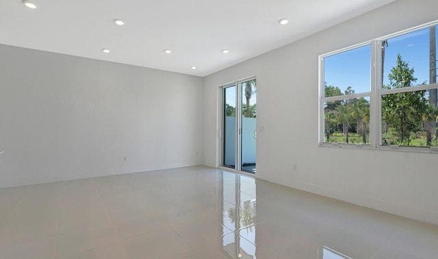 unfurnished room with a wealth of natural light and light tile patterned floors