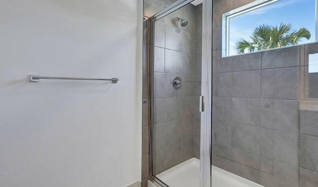 bathroom with a shower with shower door