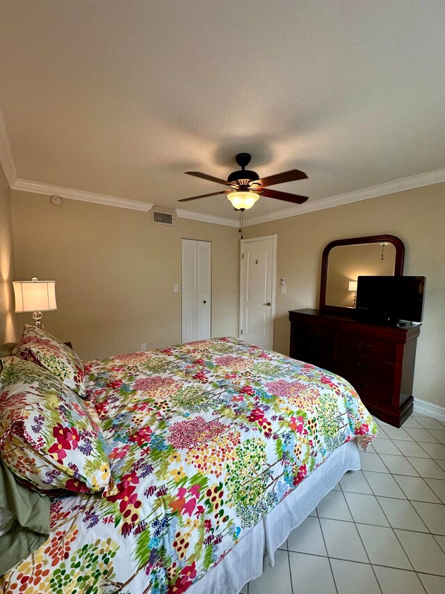 tiled bedroom featuring crown molding and ceiling fan