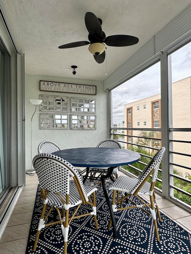 sunroom / solarium featuring plenty of natural light and ceiling fan