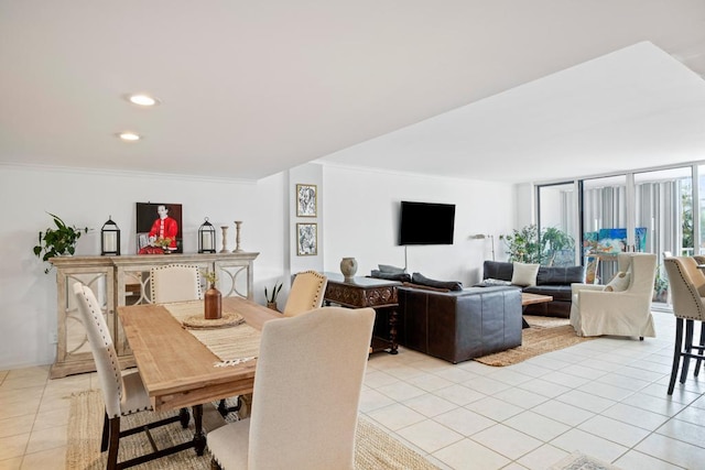 tiled dining area featuring ornamental molding