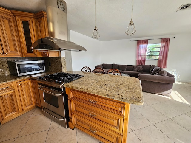 kitchen featuring decorative backsplash, light tile patterned floors, appliances with stainless steel finishes, island range hood, and kitchen peninsula