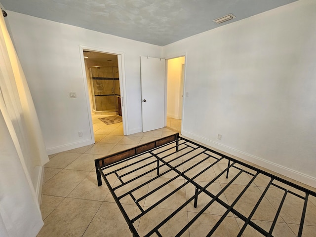 unfurnished bedroom featuring light tile patterned flooring