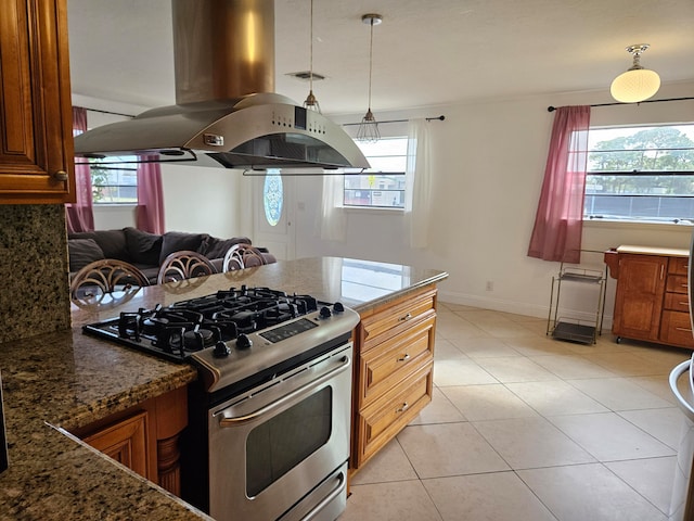 kitchen featuring island range hood, plenty of natural light, hanging light fixtures, and stainless steel range with gas stovetop