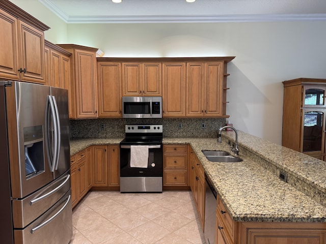 kitchen featuring sink, light stone counters, ornamental molding, kitchen peninsula, and appliances with stainless steel finishes