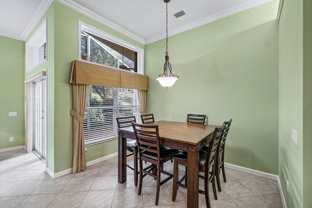 tiled dining area featuring crown molding