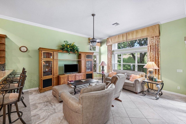 living room with ornamental molding and light tile patterned floors