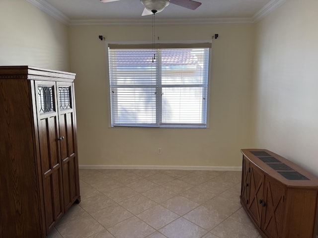 tiled empty room featuring ceiling fan and crown molding