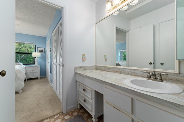 bathroom featuring vanity, baseboards, and a textured ceiling