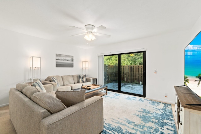 living room featuring baseboards and a ceiling fan