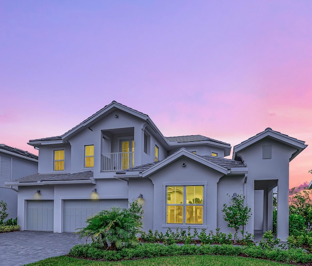 front of property with a balcony and a garage