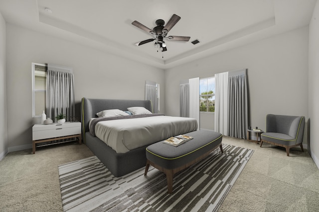 bedroom featuring ceiling fan, carpet, and a raised ceiling