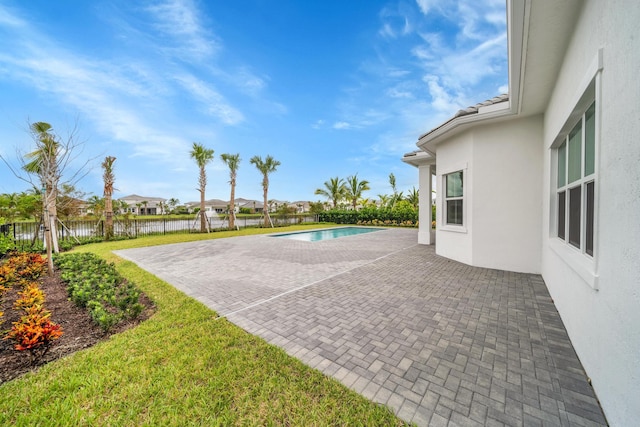 view of swimming pool featuring a patio area and a yard