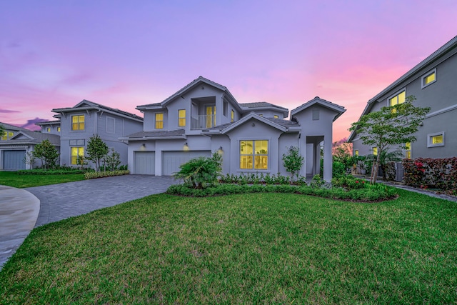 view of front facade featuring a garage and a lawn