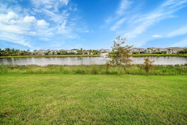 view of swimming pool with a lawn