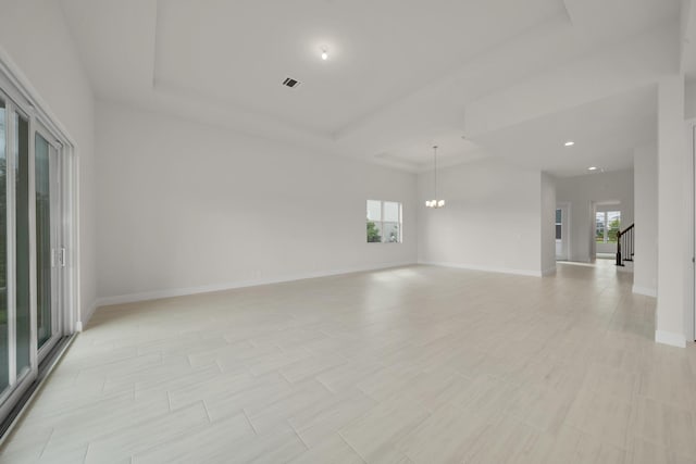 spare room featuring a notable chandelier