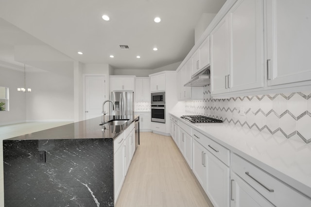 kitchen with decorative backsplash, white cabinets, light stone countertops, sink, and stainless steel appliances