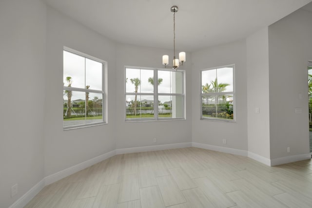 spare room with a notable chandelier