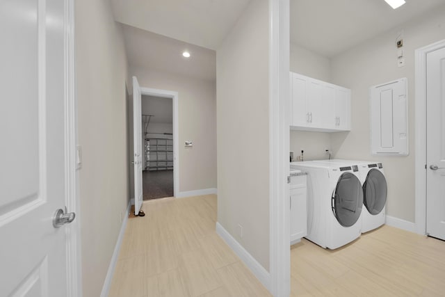 washroom featuring cabinets and washer and dryer