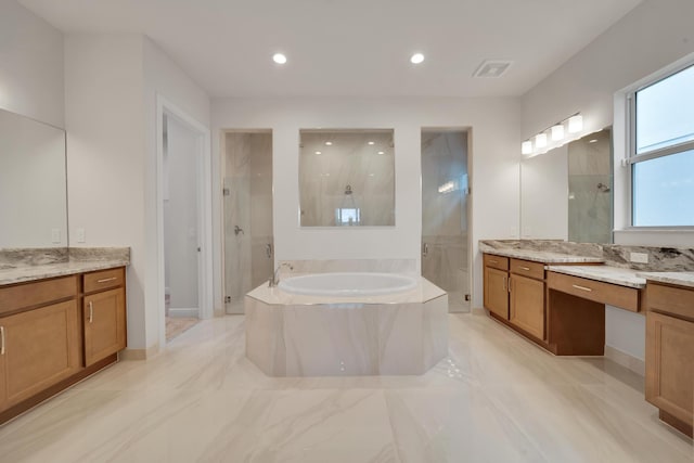 bathroom featuring vanity and shower with separate bathtub