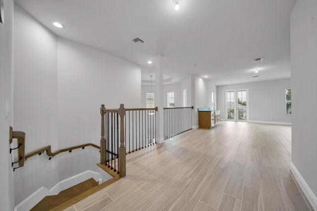 hallway with light hardwood / wood-style flooring