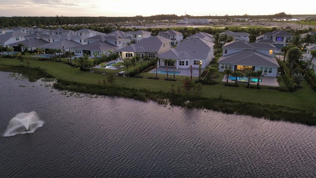 aerial view at dusk with a water view