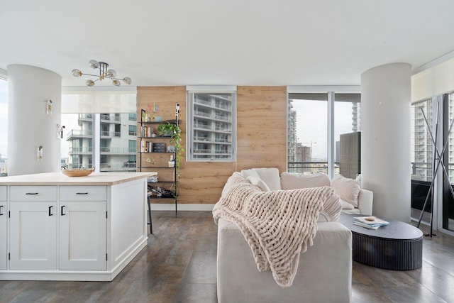 kitchen with wood walls, white cabinets, and dark wood-type flooring