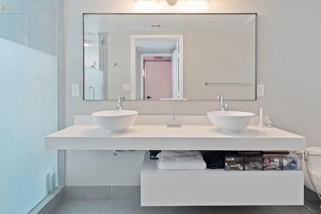 bathroom with vanity, toilet, and tile patterned floors