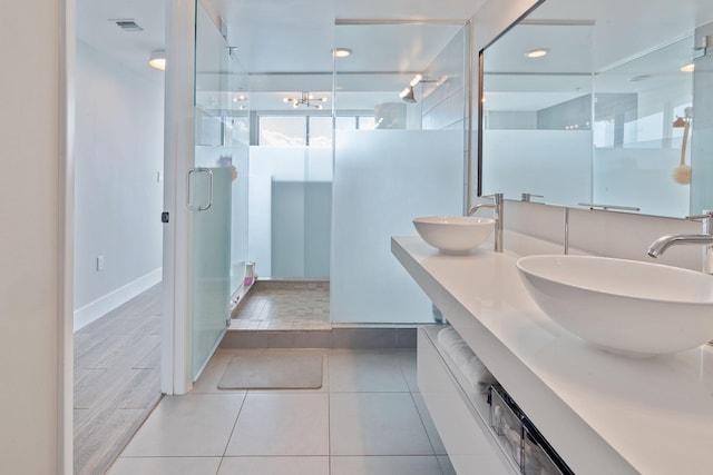 bathroom with vanity, tile patterned flooring, and a shower with door