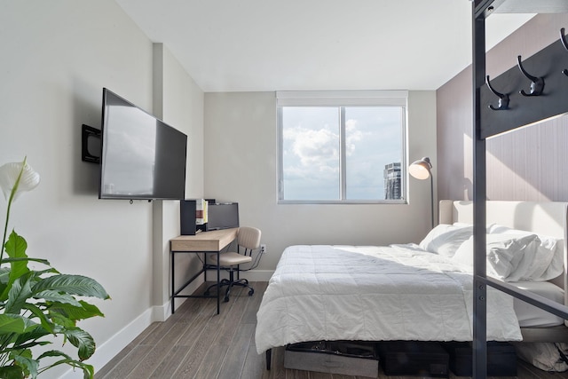 bedroom featuring wood finished floors and baseboards