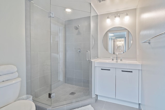 bathroom with vanity, toilet, tile patterned floors, and an enclosed shower