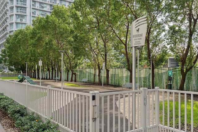 view of home's community featuring fence
