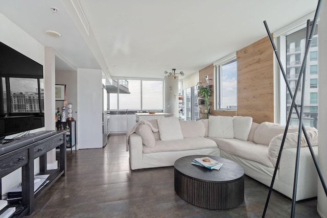 living room featuring a chandelier and a wall of windows