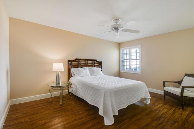 bedroom with dark hardwood / wood-style floors and ceiling fan