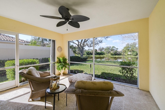 sunroom / solarium featuring ceiling fan, a water view, and plenty of natural light