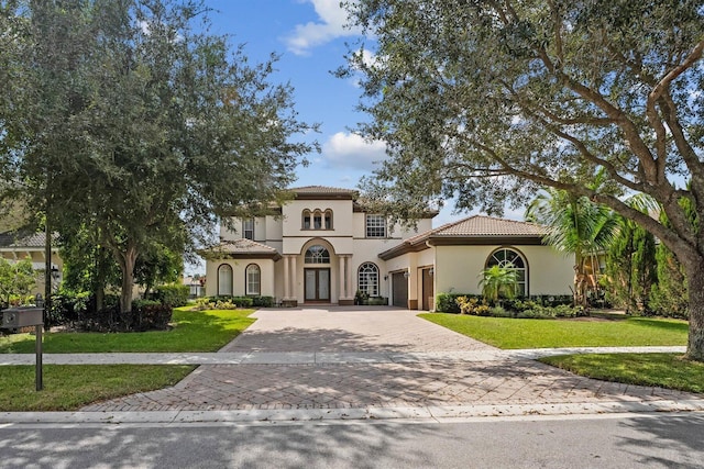 mediterranean / spanish-style home with a front yard