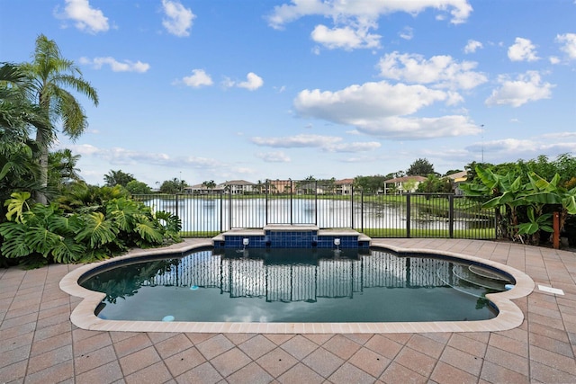 view of swimming pool featuring a patio area, an in ground hot tub, and a water view